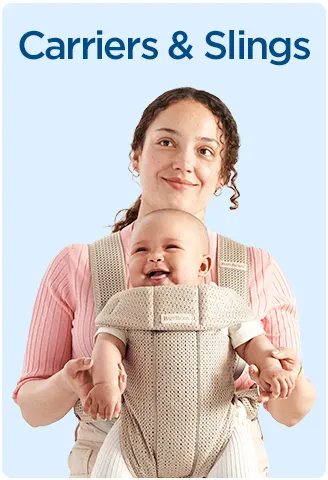 Mother carrying her baby in a soft front baby carrier with supportive straps.